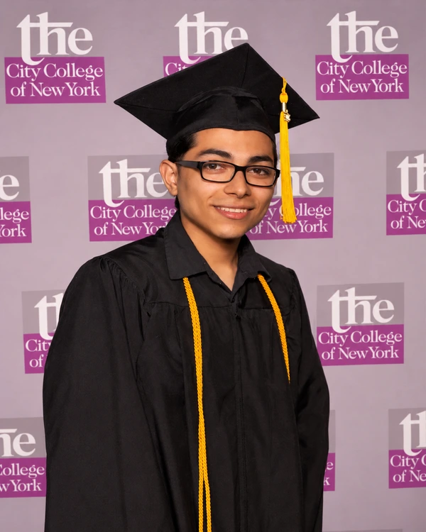 Chris in cap and gown at his City College of New York graduation